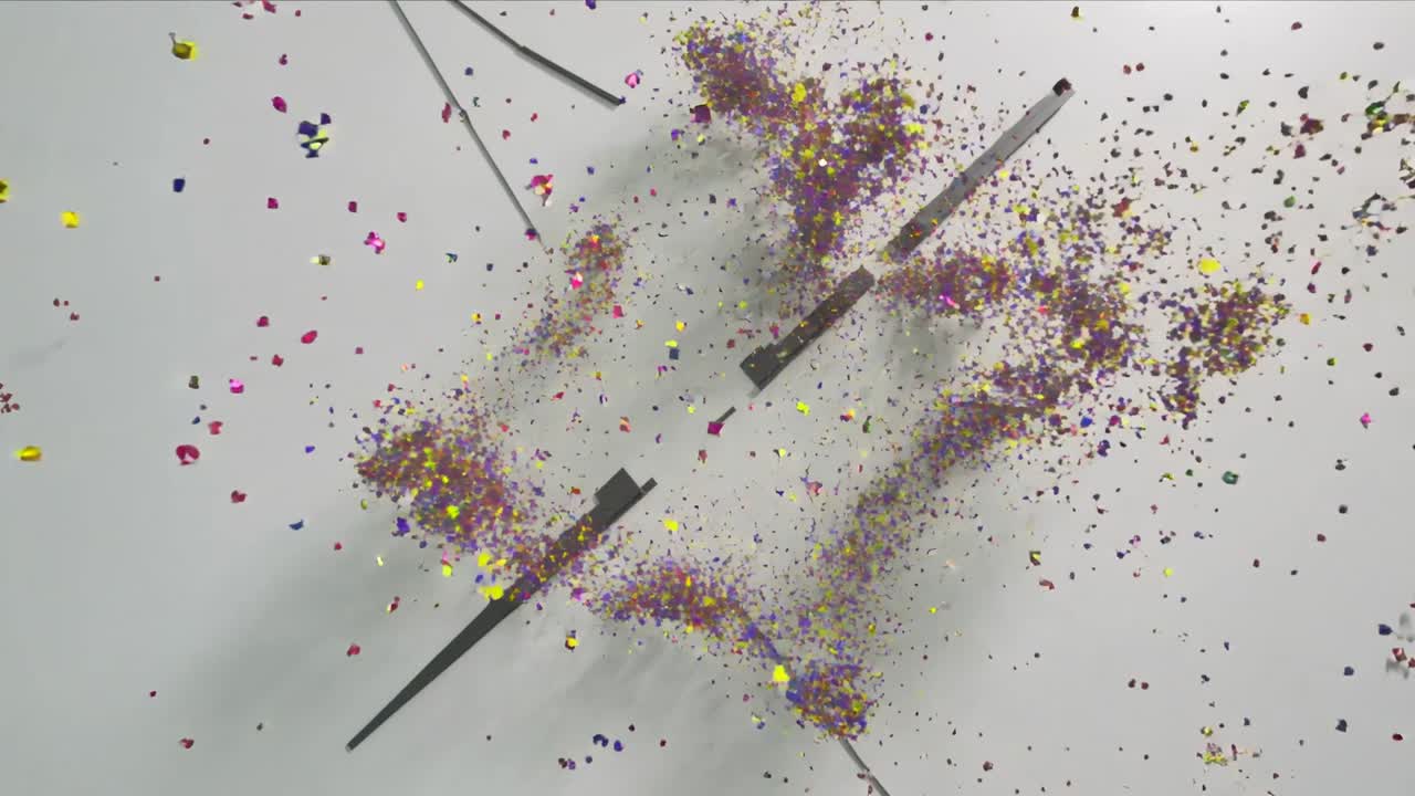 Bursting central particle cluster expanding out in studio, ejecting colored cubes and drifting rods