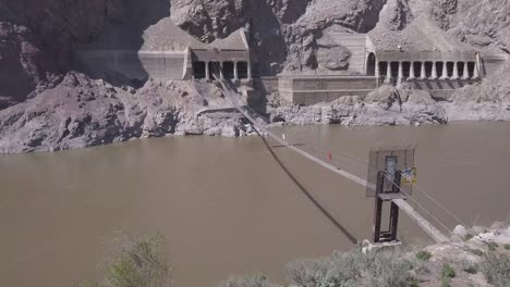 private suspension walking bridge over river canyon to railway tunnel