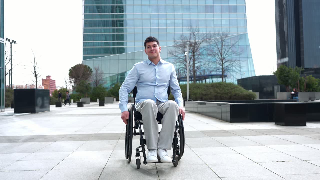 Young Man in Wheelchair Moving Forward in Modern Business District