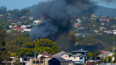 billowing thick black smoke and large lapping flames can be seen from miles away from a terrifying suburban fire