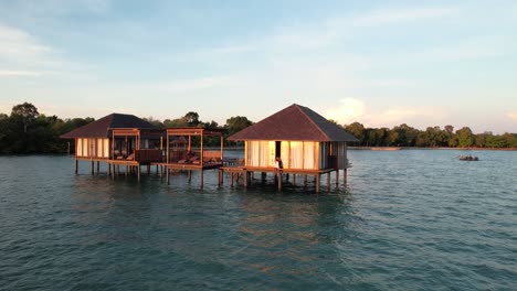 woman sitting at a bungalow enjoying sunset at a private island in belitung indonesia