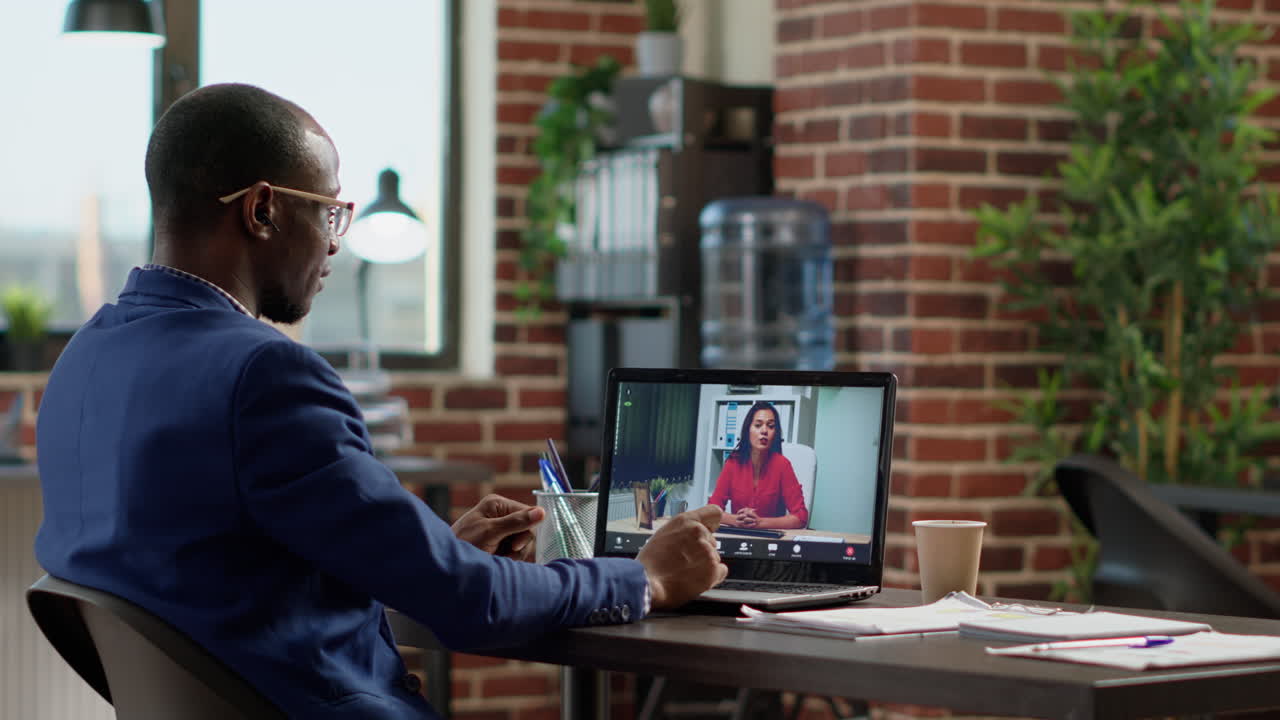 African american worker meeting with businesswoman on online video call