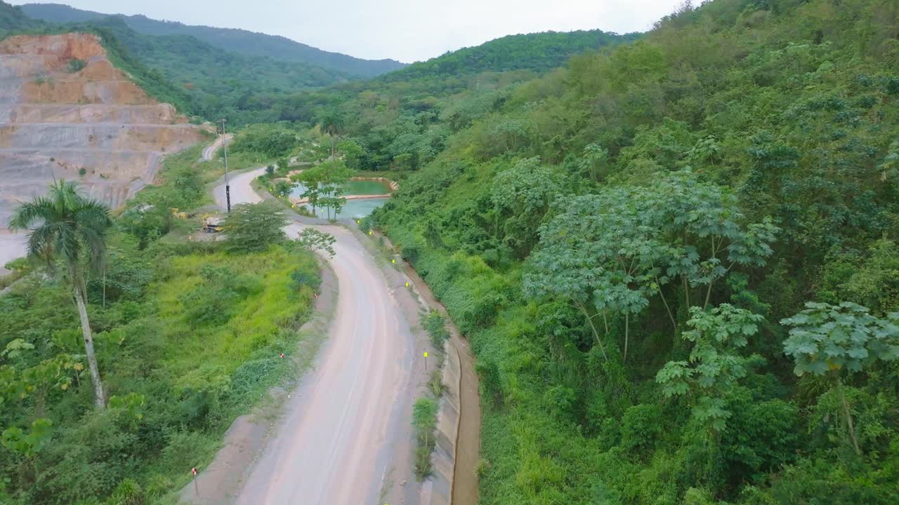 Aerial view of access road near Barrick Gold mine's water purification area, landscape and infrastructure for environmental management, Cotui, Dominican Republic. Aerial drone