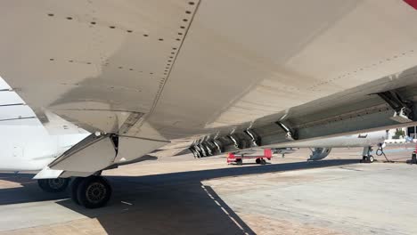 close up low angle view of the right wing of a medium size jet while operating slats and flaps