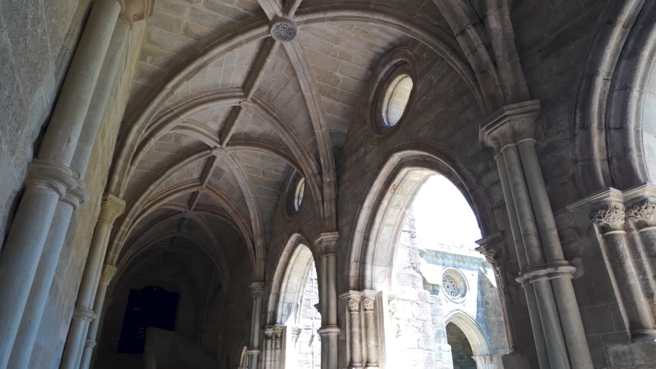 Gothic stone cloister with vaulted ceilings and arched windows portugal