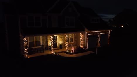 large american home with christmas lights at night