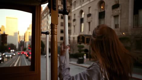 woman using a tram on a city street