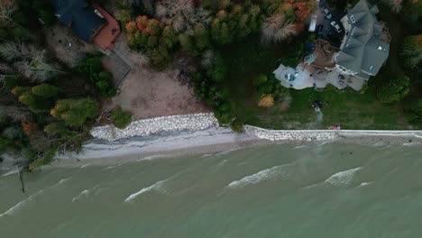 epic-top-down-of-a-vacation-home-on-the-lake-with-a-private-tennis-court-with-autumn-foliage