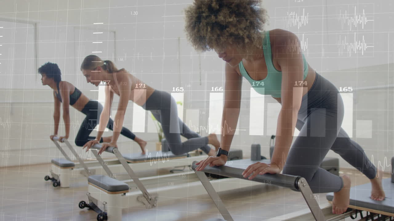 In gym, women exercising on reformer machines with animation showing fitness data