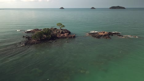 aerial descending tilt up shot of a group of tropical islands in the gulf of thailand