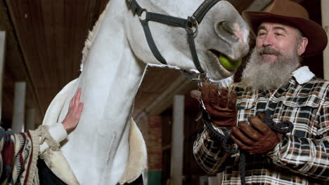 couple with horse indoors