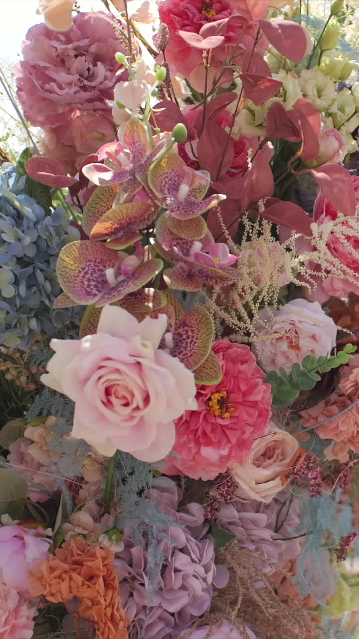 Wedding arch with colorful flowers, dolly moving shot, cinematic atmosphere, vertical video