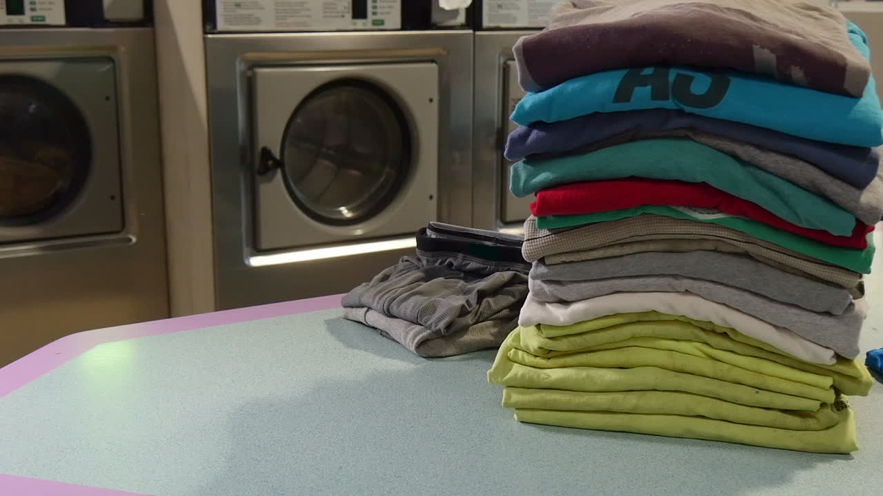 folded clothing on laundromat counter