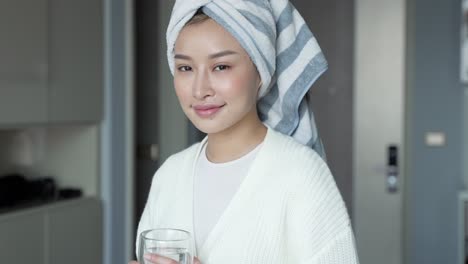 woman drinking water after shower