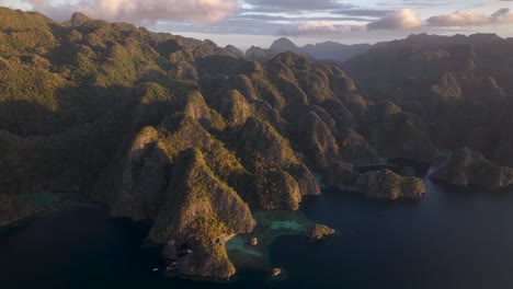 coron island is bathing in warm golden light, sunset in palawan, philippines. aerial drone