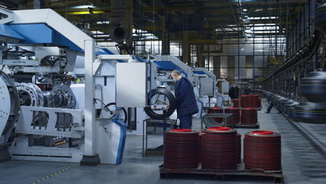 workers at tyre manufacture inspecting rubber product quality working process