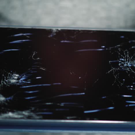 a man holds a tablet with a broken screen 1