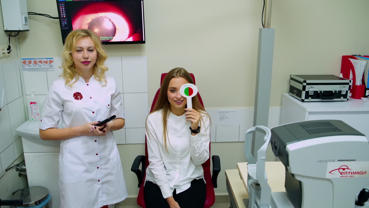 Woman visiting ophthalmologist. Woman doing eye test with optometrist in medical office