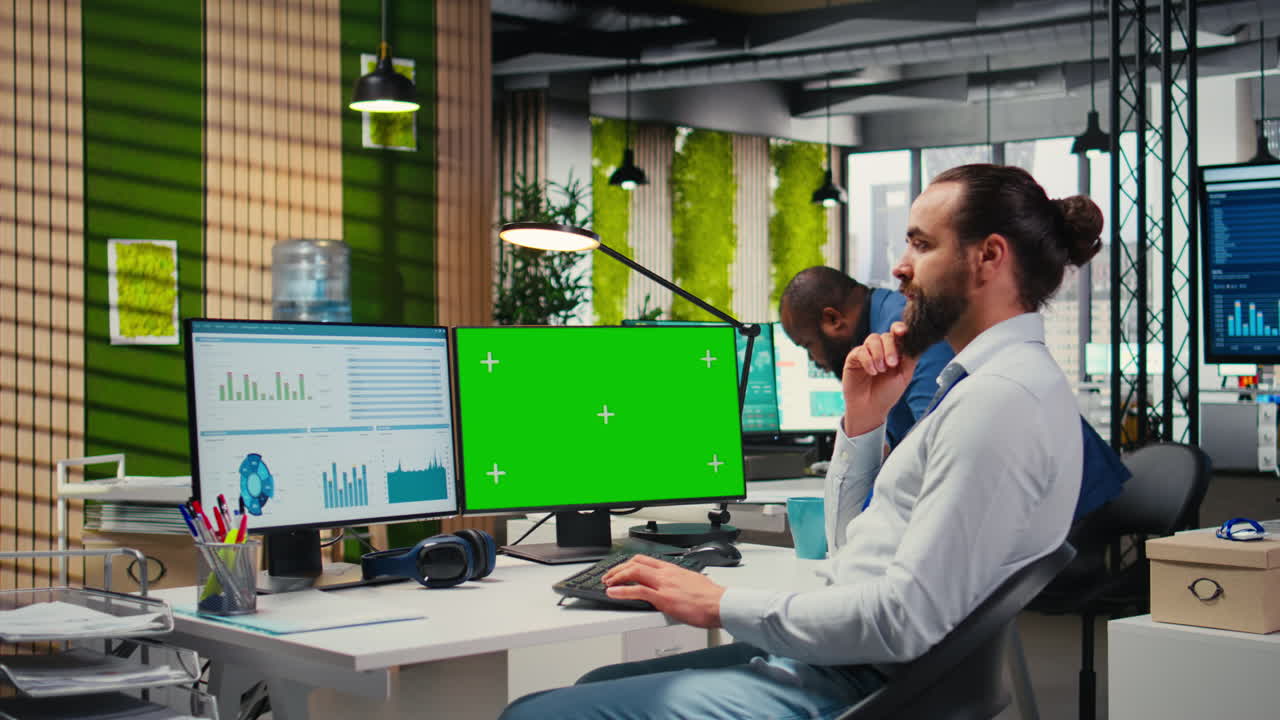 Vertical Video Employee engaged in business planning with a green screen in the office