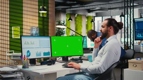 vertical video employee engaged in business planning with a green screen in the office