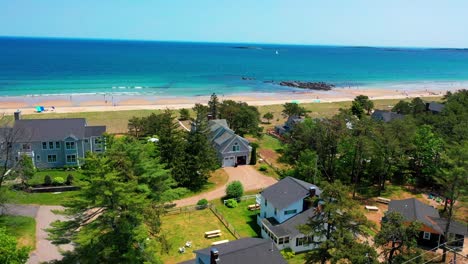 aerial video of a scenic maine beach house with sandy yard and panoramic atlantic views. big patio, deck, and windows make this prime real estate perfect for family getaways and vacation fun