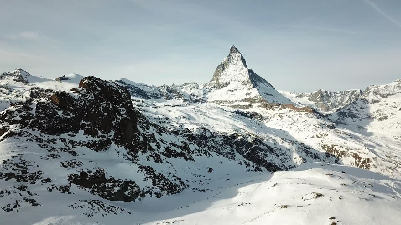 aerial footage of world famous iconic swiss mountain peak Matterhorn above Zermatt town Switzerland, in winter time