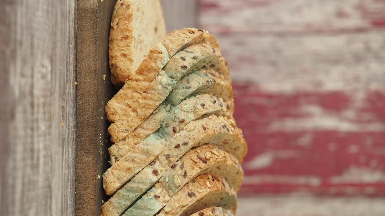 Moldy Sliced Bread on Wooden Cutting Board