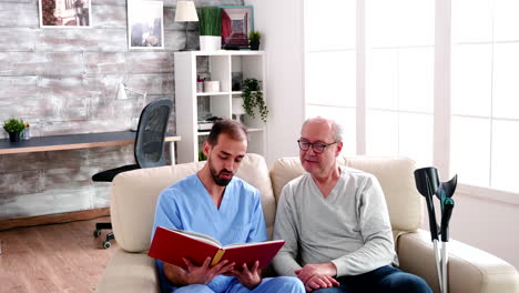 male helper reading a book for old man