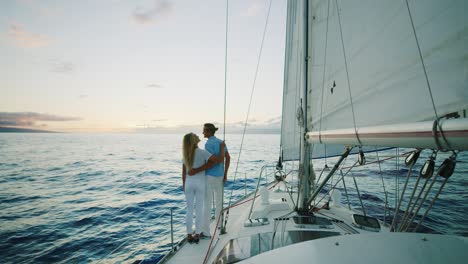 couple sailing on yacht at sunset