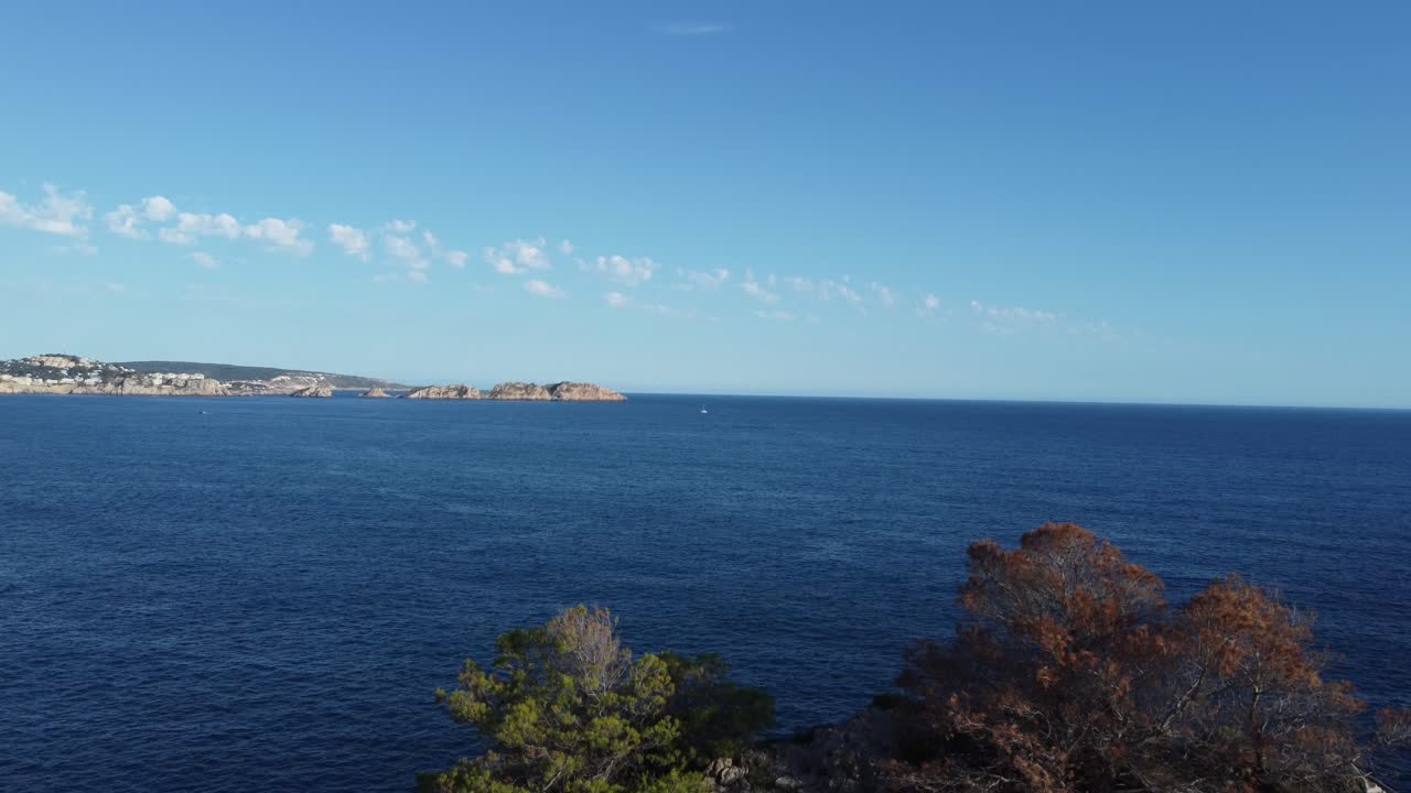 High altitude 4K Drone view onto Islands in the Baleares Mallorca spain as drone is descending down until a rock formation comes into view