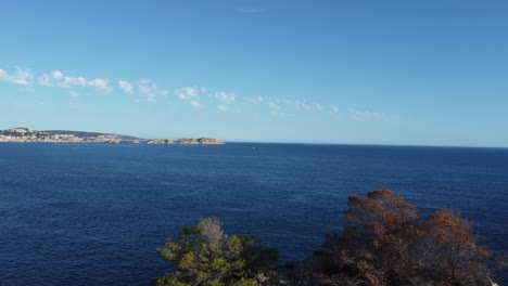 high altitude 4k drone view onto islands in the baleares mallorca spain as drone is descending down until a rock formation comes into view