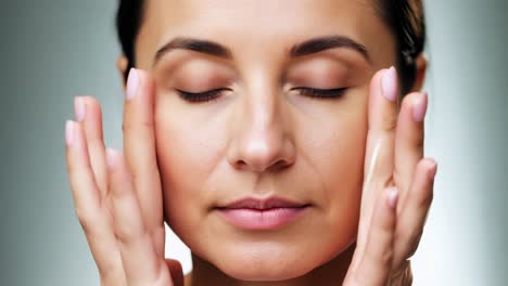 woman applying facial treatment