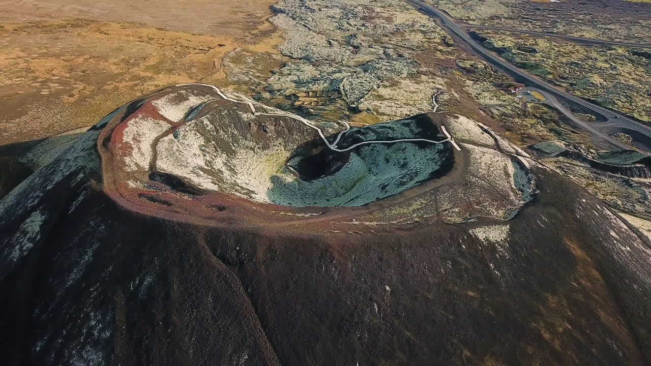 Close up 4k aerial flight of a large crater formed by a volcano