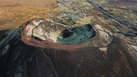 close up 4k aerial flight of a large crater formed by a volcano