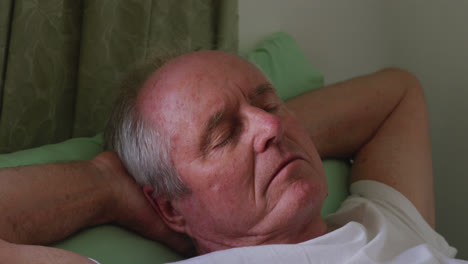 senior man in social distancing sleeping in retirement house