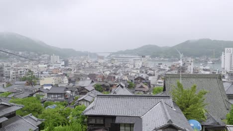high above panning shot across beautiful onomichi, hiroshima cityscape
