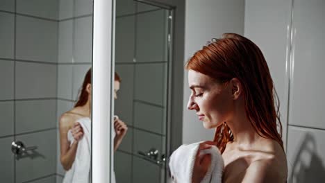 woman drying hair in bathroom