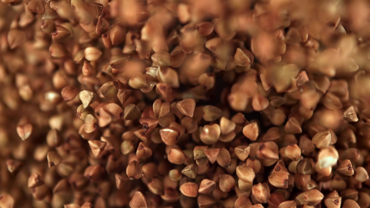 Raw Buckwheat Grains Falling in Super Slow Motion