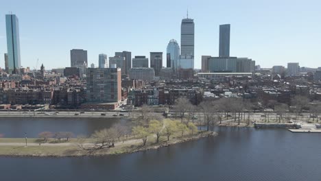 boston, massachusetts. riverfront against cityscape. establisher traveling shot