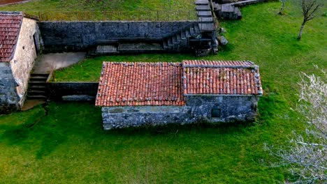 Aerial-View-Of-Old-Traditional-Clay-Roofing-Tiles-On-Abandoned-Buildings-Tordoia-Coruna,-Spain