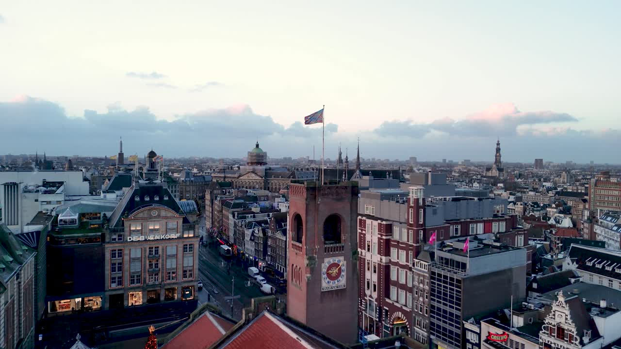 Experience the breathtaking view of Amsterdam's skyline as the sun sets, highlighting the beautiful historic buildings and bustling streets, creating a magical atmosphere