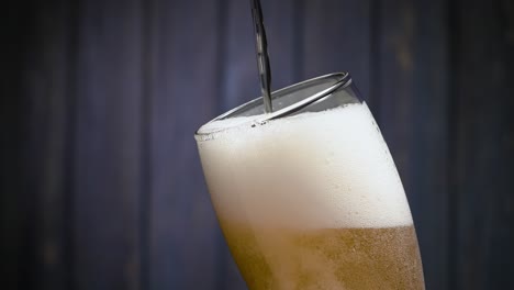 golden beer poured into a glass with frothy foam