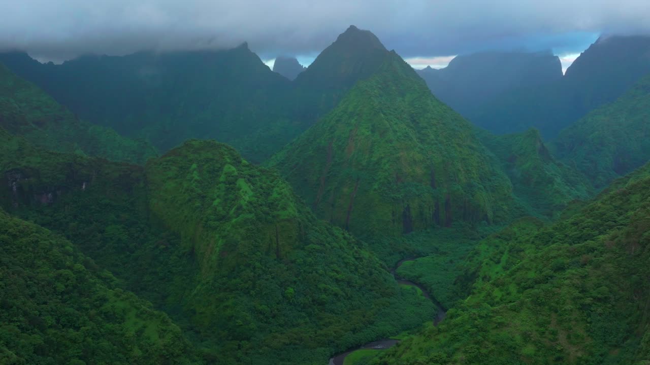 Cloudy morning towering jagged mountain peaks Vallee de Tautira River Tahiti island French Polynesia aerial drone Valley Bay Teahupoo Mont Rauiri Aorai Taiarapu Taravao forward parallax motion