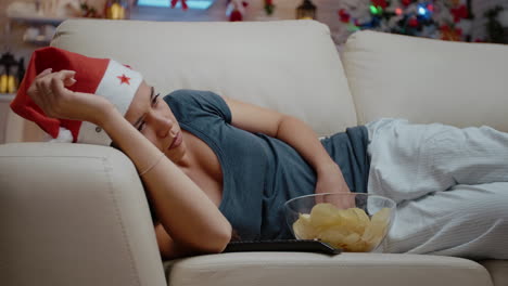 Close up of woman falling asleep while watching television
