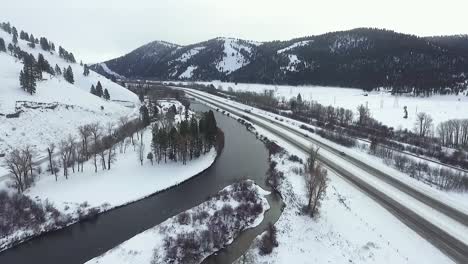 aerial - cars travel on interstate along flowing river