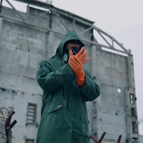Man wearing hazmat suit in polluted zone. Worker in protective suit, mask and gloves in abandoned place with biological attack threat
