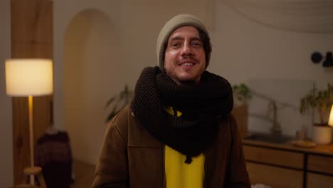 man wearing warm clothes in a cozy living room