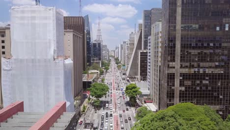 busy street of sao paulo, brazil on a sunny summer day with buildings, antennas, and cars - an aerial shot of avenida paulista