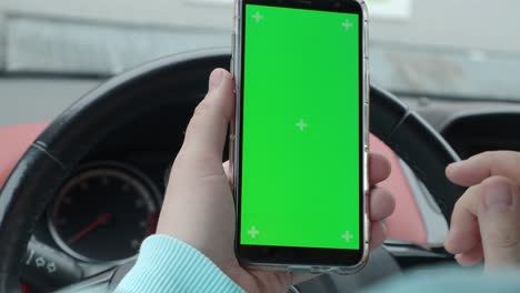 un hombre en un coche con una pantalla verde de teléfono