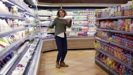 Full-Length-Footage-Of-Young-Woman-Dancing-Through-Grocery-Store-Aisles